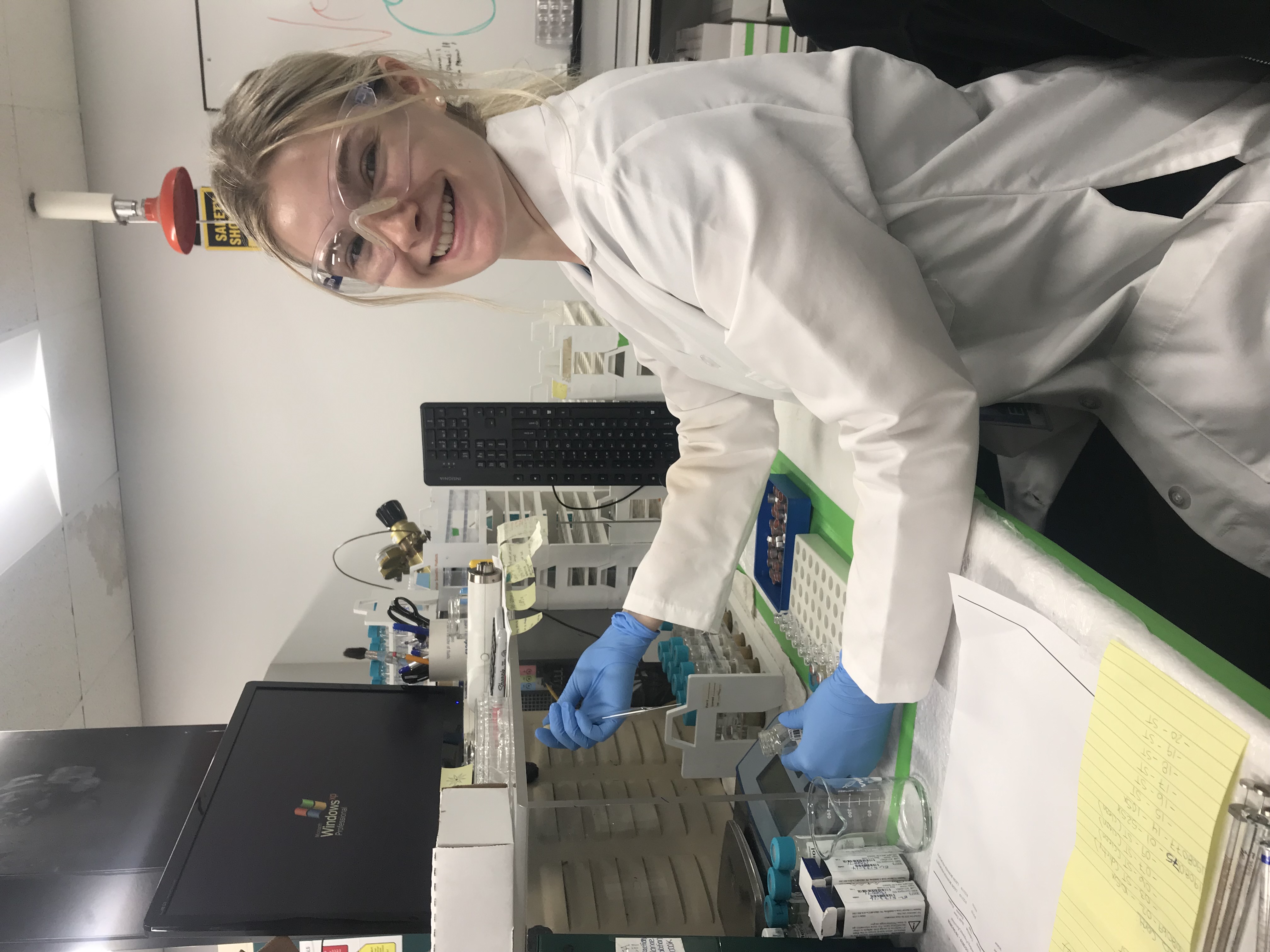 Rachel at a lab bench pipetting sample at Michigan government environment lab