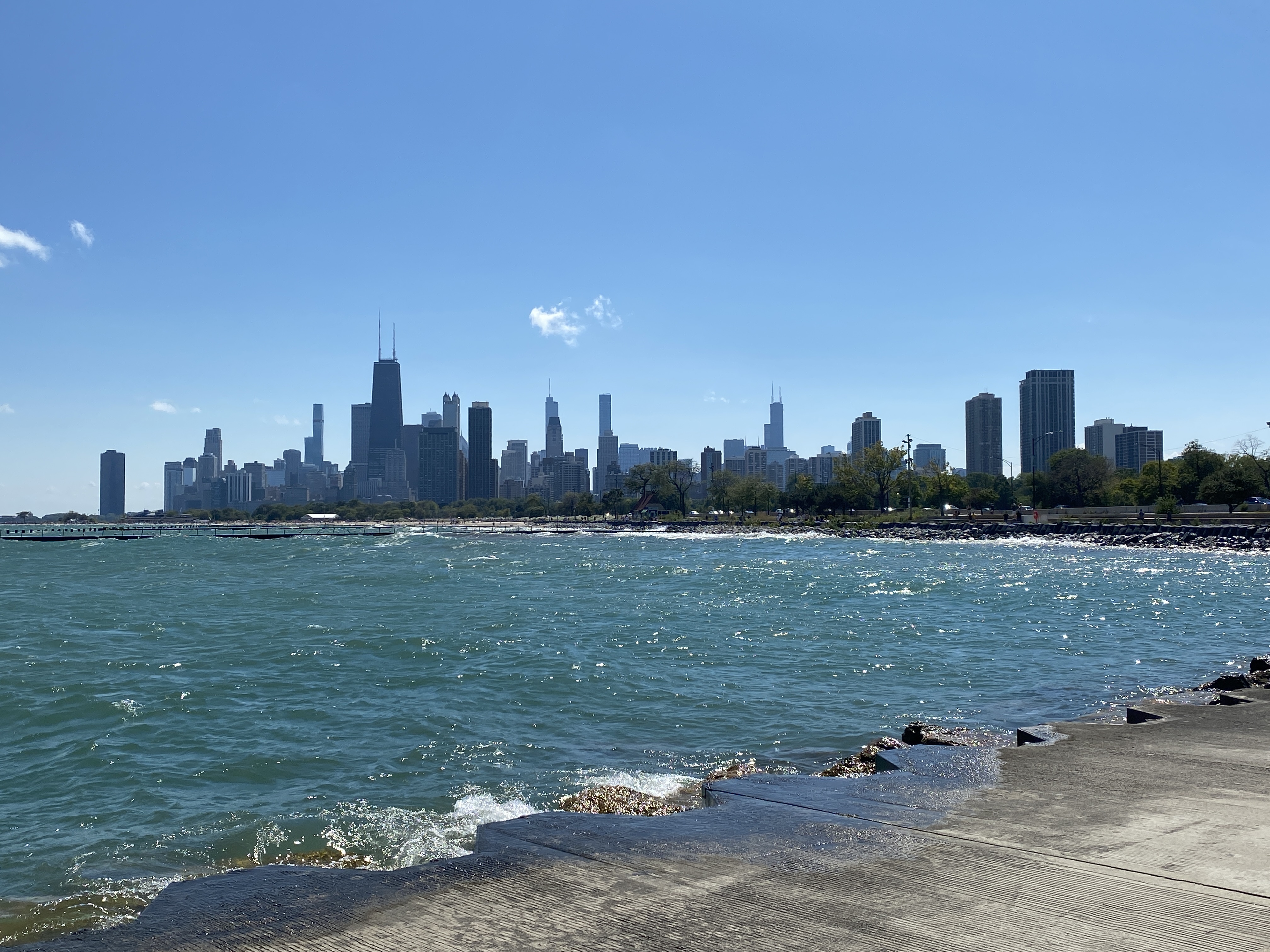 Photo of chicago skyscrapers and concrete beach of lake Michigan